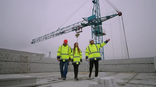 People in Hardhats are Walking in Construction Site Viewing Process of Building Inspectors and Civil