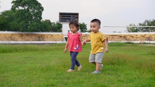 Little Boy And Little Girl Holding Hand And Walking Together