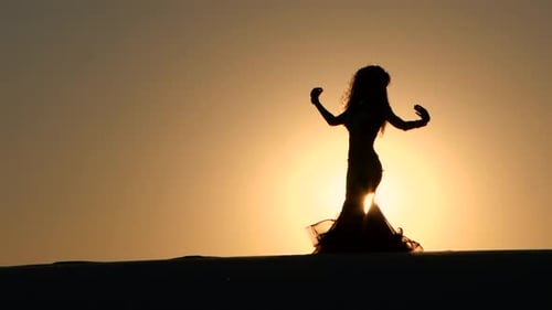 Silhouette of Woman Belly Dancing at Sunset