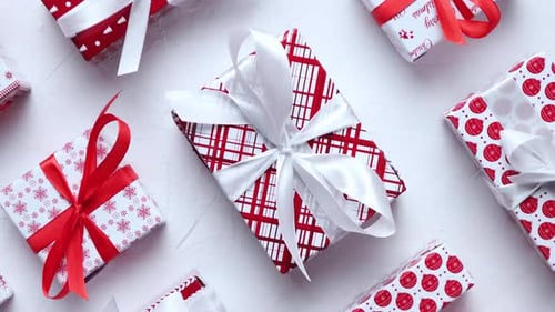 Colorful White and Red Christmas Theme. Wrapped Gifts in Festive Paper with Ribbon