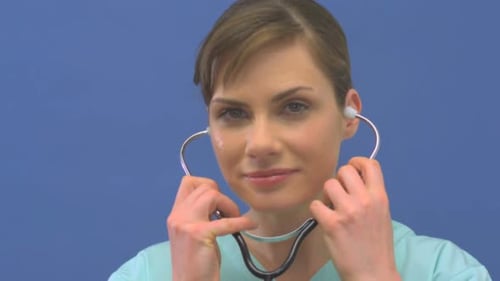 Woman Doctor Puts Stethoscope in Ears