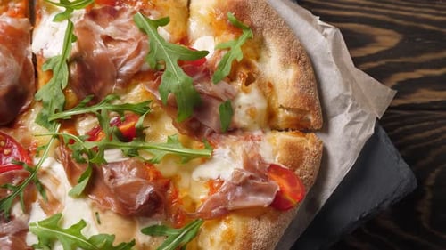 Prosciutto Pizza with Strachatella Cheese Tomatoes and Arugula Leaves