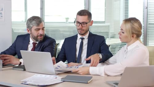 Business Team Discussing Data in Modern Office