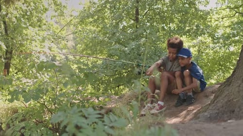 African American Siblings Fishing by River