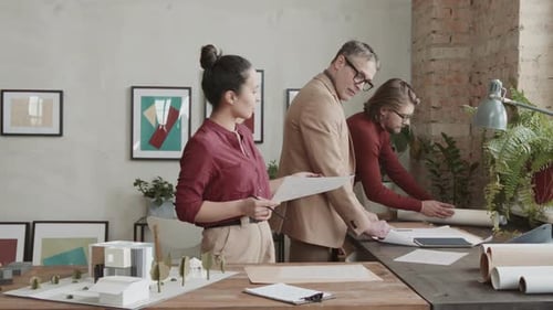 Team Of Architects Working On House Design In Office