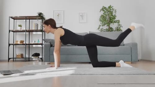 Woman Exercising at Home with Online Workout Class