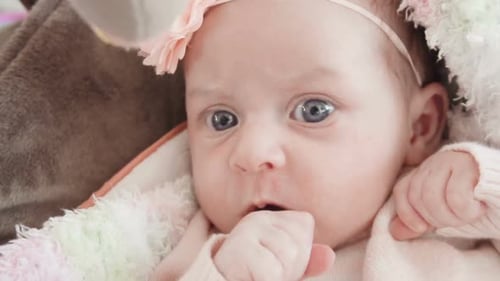 Adorable Infant with Flower Headband Lying Comfortably