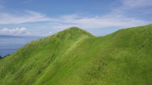 Aerial View of Tropical Blue Ocean Bay and Green Hills.