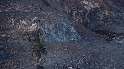 Army Soldier with Rifle in Action in Mountains