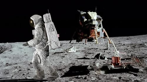 Astronaut Walking on Moon Surface with Lunar Module