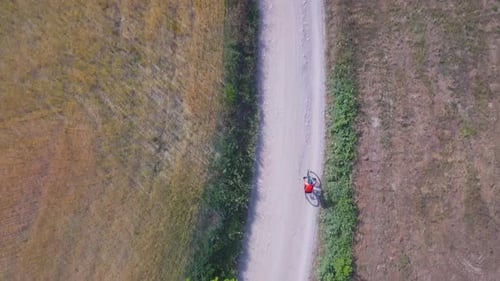Man cycling with mountain bike on countryside road