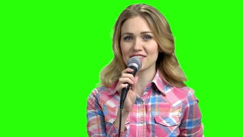 Young Woman Presenter Holding Microphone on Green Screen.