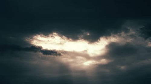 Sunlight Streams Through Dark Dramatic Clouds