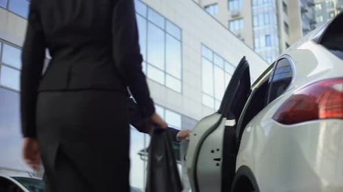 Man and Woman by Car in Urban Setting