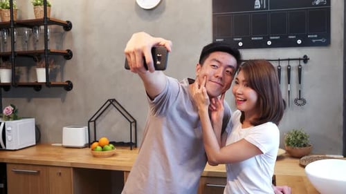 Young Couple Taking a Selfie in Kitchen Together