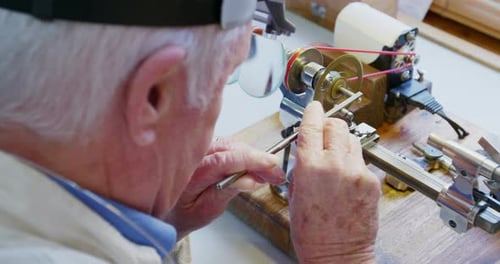 Senior Craftsman Working with Precision Equipment