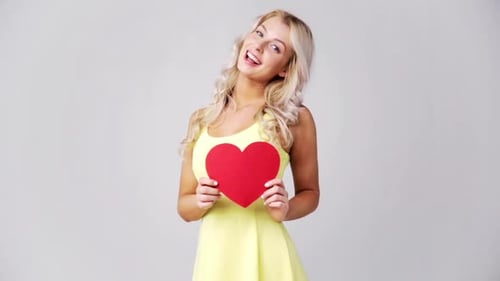 Blonde Woman Holding Heart