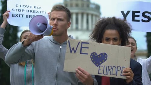 Protesters Rallying with Megaphone and Signs in City