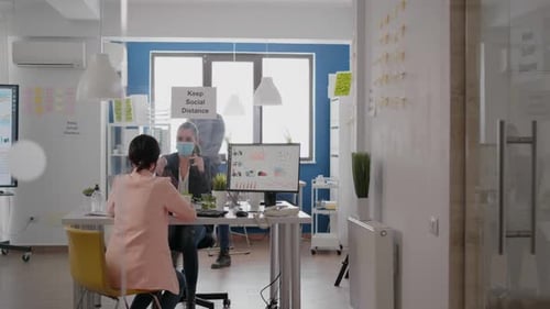 Coworkers Meeting in an Office with Face Masks