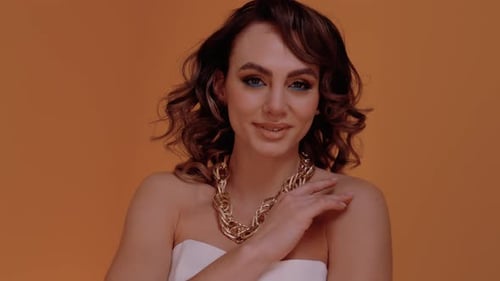 Stylish Woman Posing with a Gold Necklace