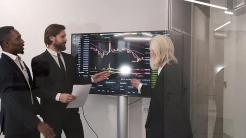 Businessmen Checking Stock Market on Digital Board