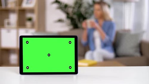 Tablet Computer with Green Screen on Table at Home 101
