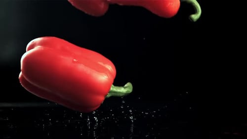 Red Sweet Peppers Fall on the Table