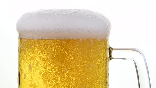 Beer Pouring into Glass Mug with Foam