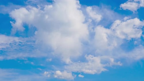 Clouds Drifting Peacefully in a Brilliant Blue Sky