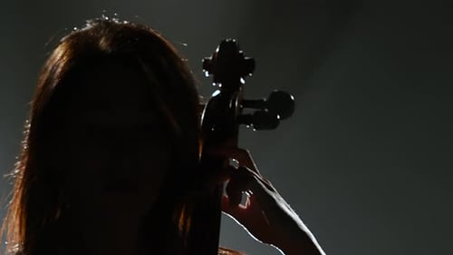 Woman Plays Cello in Dramatic Light