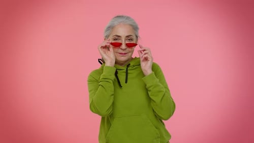 Senior Woman Posing with Geometric Red Sunglasses