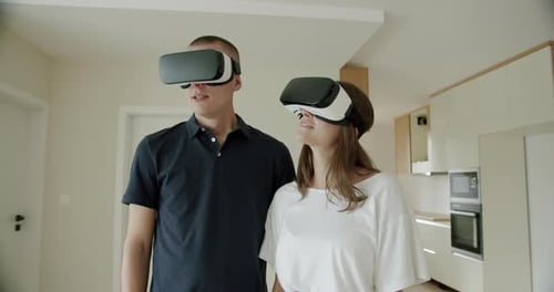 Young Couple Experiencing Virtual Reality Headsets at Home