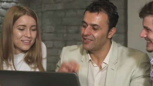 Close Up of a Creative Team Working Together on the Computer at the Office