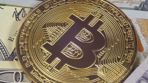 Bitcoin Coin on Top of US Currency