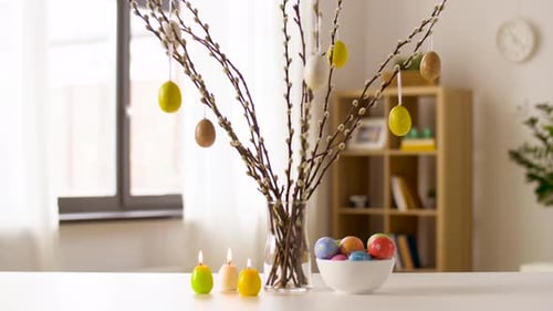 Easter Eggs, Willow and Candles Burning at Home