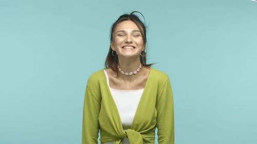 Happy Young Woman Laughing on Blue Background
