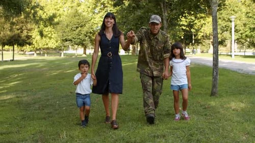 Happy Military Family Walks in Sunny Park