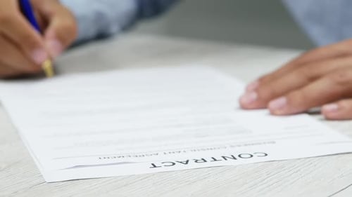 Close-up Businessman Putting Signature on Paper. Signs a Contract. Successful Deal, Negotiations.
