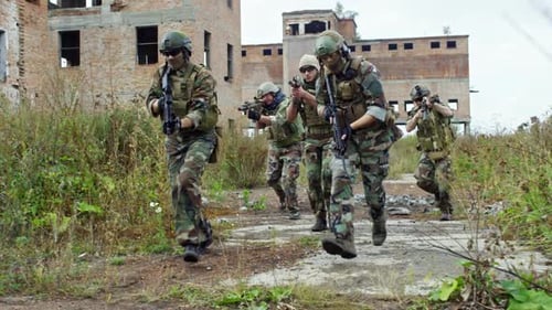 Sniper Team Running through Destroyed Area