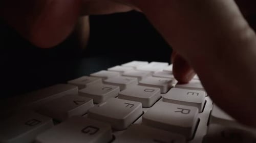 Tippen in Nahaufnahme auf der Tastatur mit den Hauptfingern. Makro-Dolly-Aufnahme mit weichem Fokus
.