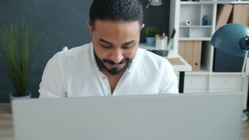 Successful Middle Eastern Businessman Working with Computer Typing in Office