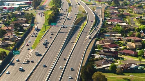 Highway Traffic Flowing Smoothly in Suburban Landscape