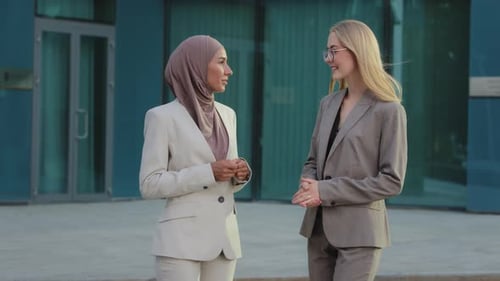 Business Women Talking Outside Office Building