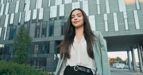 Confident Woman Stands in Front of Office Building