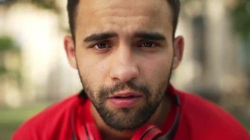 Front View Headshot of Exhausted Tired Middle Eastern Young Student Holding Head in Hands Studying