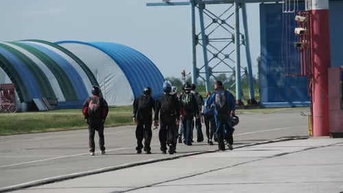 Skydiving Team Walking Toward Airplane for Jump