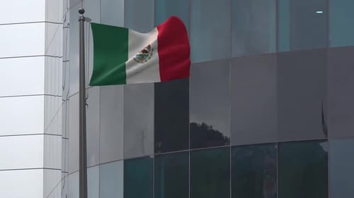 Mexican Flag Waving on Modern Office Building