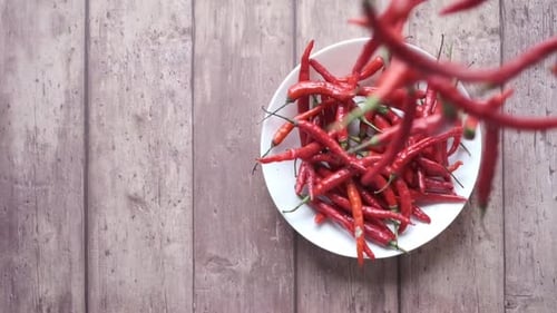 Bowl of Red Chili Peppers on Wooden Table