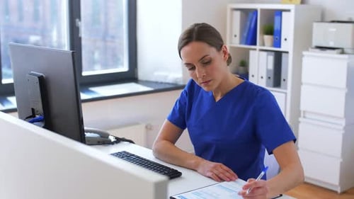 Doctor or Nurse with Computer Working at Hospital