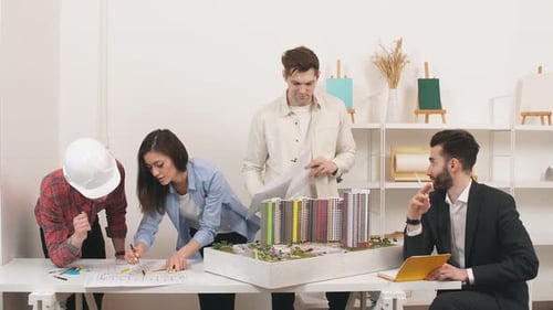 Architects Collaborate on Building Design in Modern Office